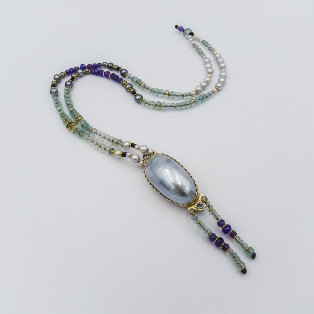 beaded necklace with 18k gold spacing,mother of pearl pendant,aqua marine,amethyst,silver&black pearls