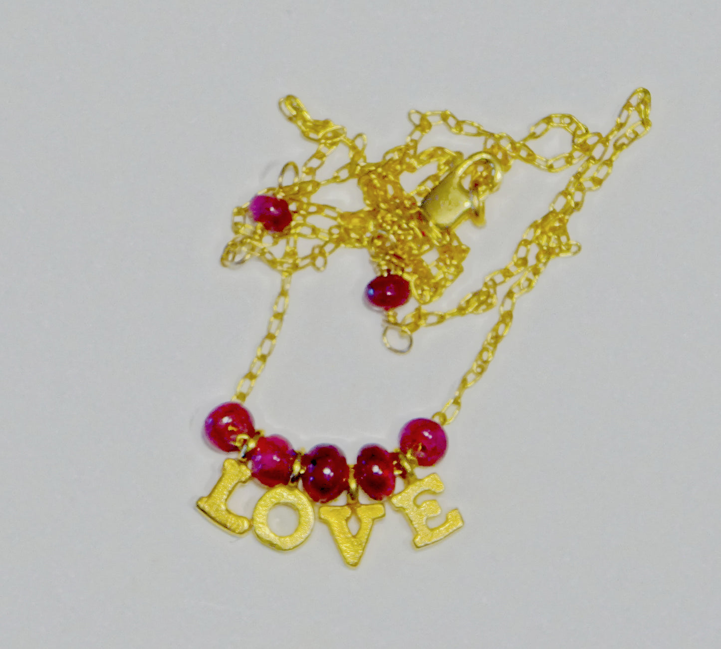 Gold filled necklace with gemstones Ruby beads with the letters love