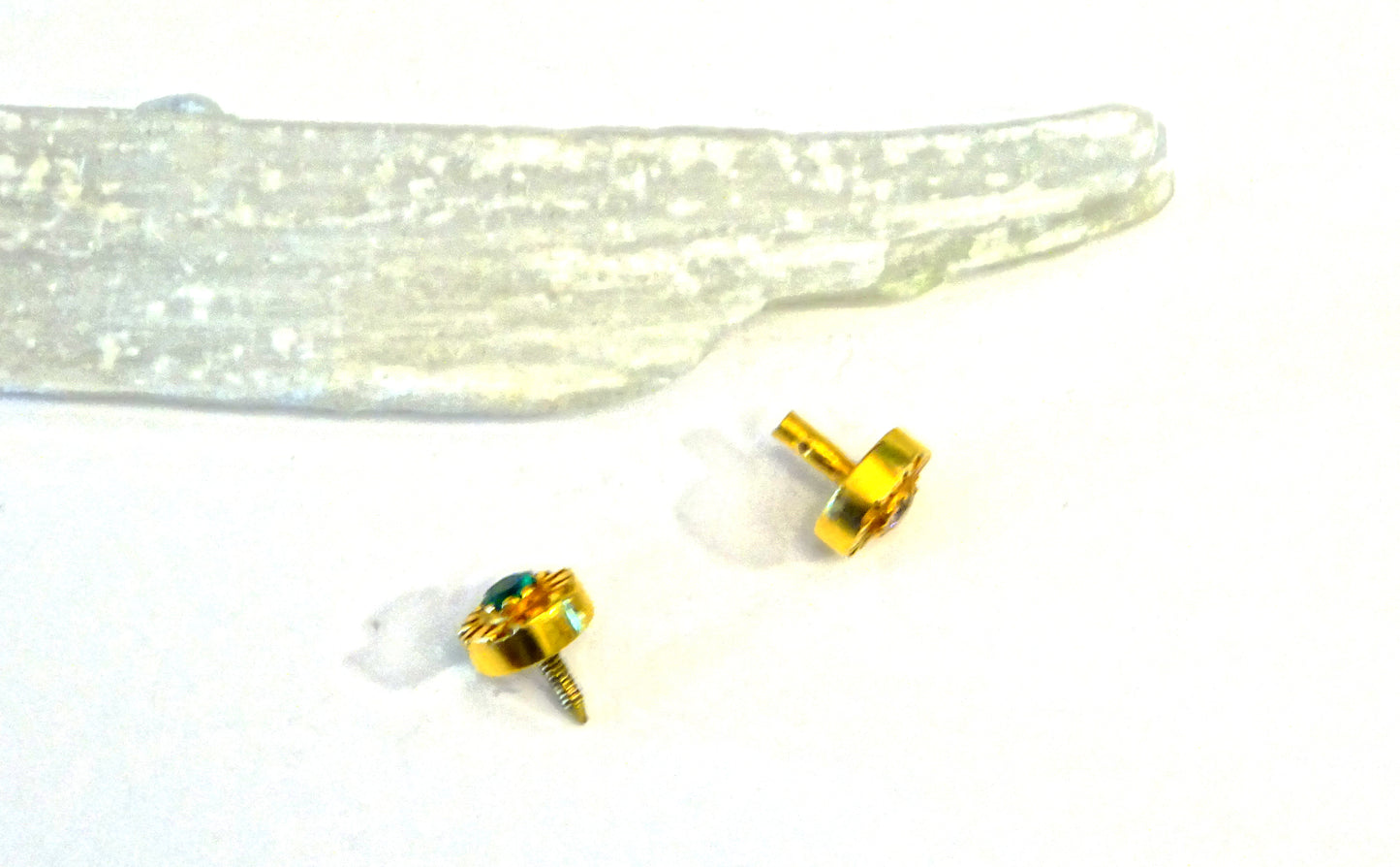 18k gold stud earring with gemstones Dabble sided ,set with a diamond and emerald